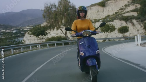 Cool motorbike rider driving scooter on road, spring wanderlust concept