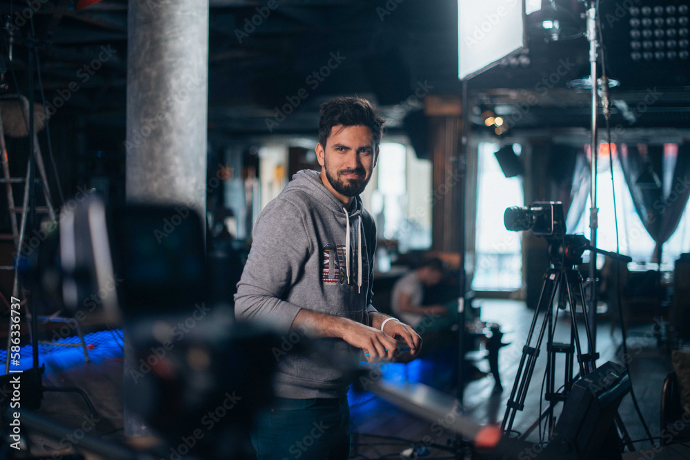 Director of photography with a camera in his hands on the set. Professional videographer at work on filming a movie Director of photography with a camera in his hands on the set. Professional videographer at work on filming a movie