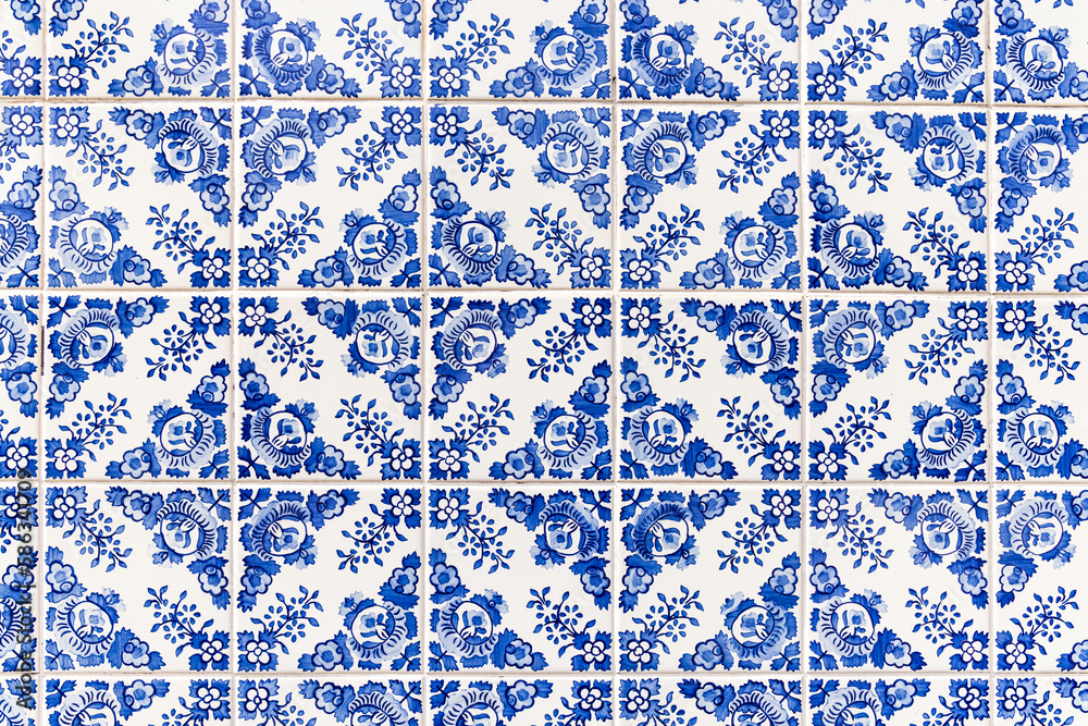 Traditional hand painted azulejos decorative tiles on a building in Porto.