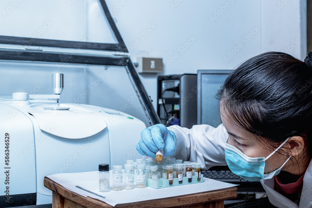 Scientist female check samples in vials before analysis with Fourier ...
