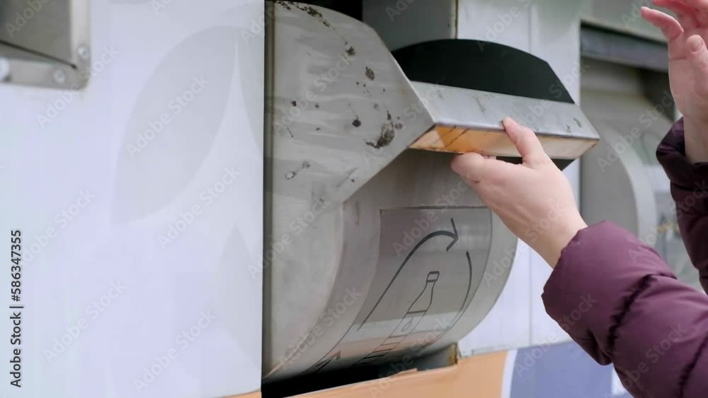 Proper waste management in action as a woman discards plastic into a recycling bin, garbage sorting concept, waste separation by diferent bin.