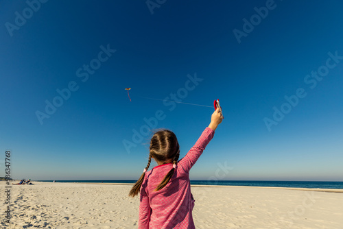 Girl flying kite at Baltic Sea, Poland