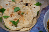 Cooked naan breads on parchent paper