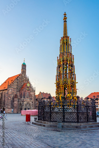 Schöner Brunnen and Frauenkirche in German town Nürnberg during sunrise photo