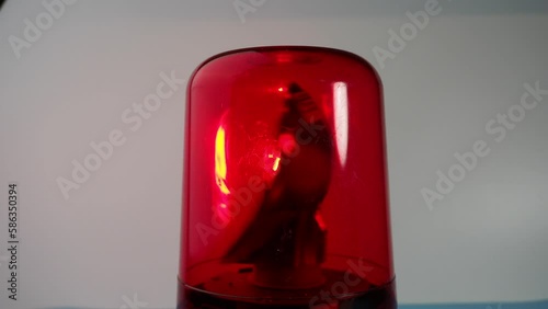 Red rotating beacon. Red flashing light. Warning signal. Close-up.