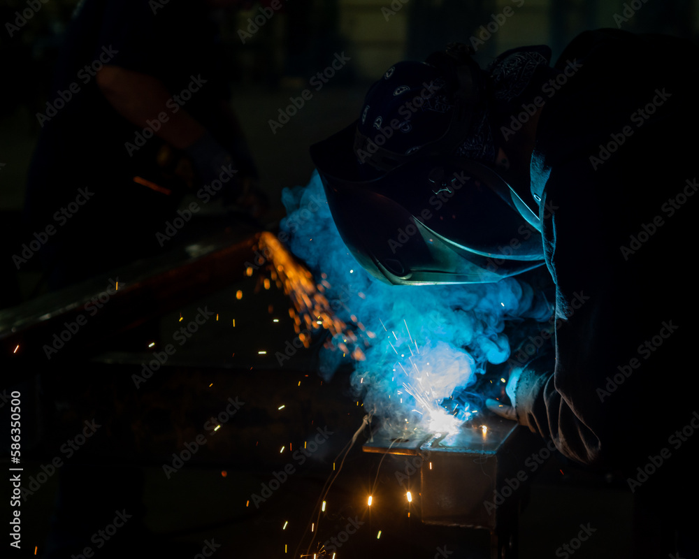 Tight photos of mig or wire welding. Smoke and sparks. - obrazy, fototapety, plakaty 