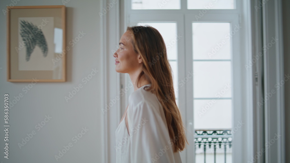 Dancing woman swirling home closeup. Relaxed lady in silk robe watching window