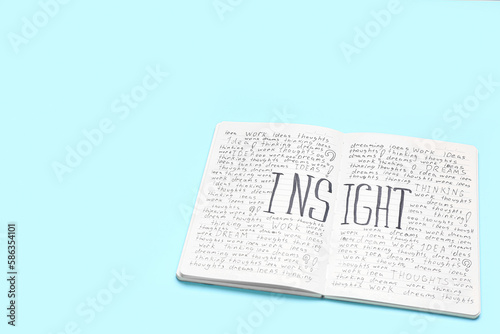 Notebook with word INSIGHT on blue background