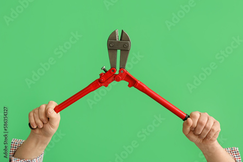Worker with bolt cutter on ...