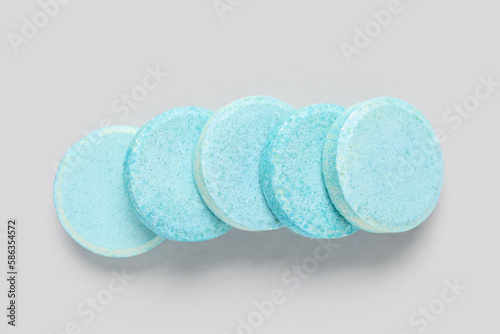 Blue soluble tablets on grey background