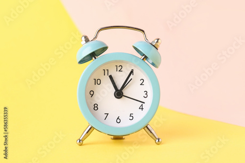 Alarm clock on color background