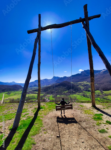 A big swing in pico Caleo, viewpoint over Lario village, Montaña de Riaño y Mampodre Regional Park, Leon province, Spain photo