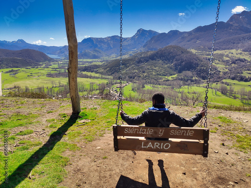 A big swing in pico Caleo, viewpoint over Lario village, Montaña de Riaño y Mampodre Regional Park, Leon province, Spain photo
