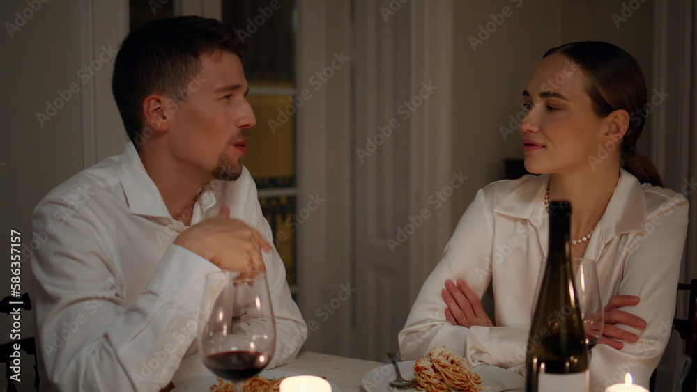 Positive man speaking at candles table room closeup. Lovers having romantic date Positive man speaking at candles table room closeup. Lovers having romantic date