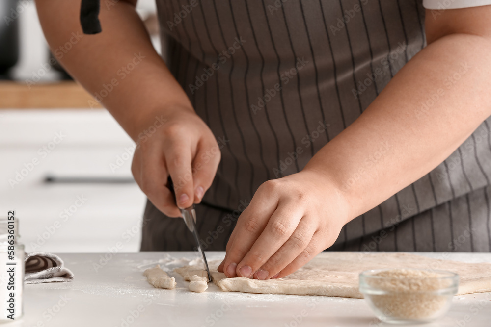Woman preparing Italian Grissini at table in kitchen, closeup Woman preparing Italian Grissini at table in kitchen, closeup