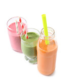 Glasses and bottle of different tasty smoothie with straws on white background