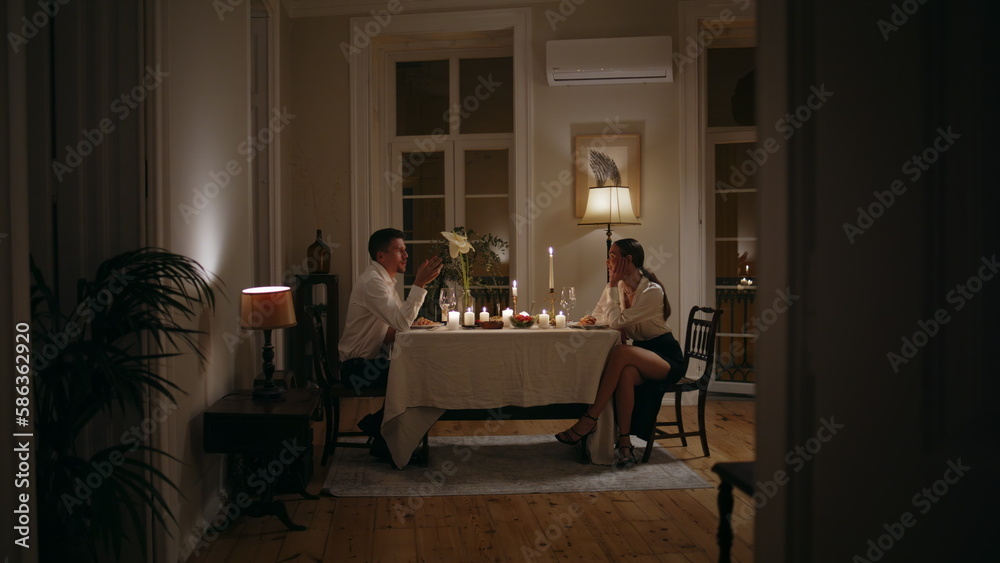 Fototapeta premium Loving couple romantic evening at home. Lovers enjoying dinner with candles