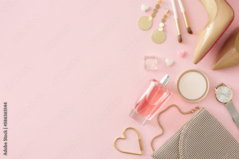 Top view photo of perfume bottle cosmetics bijouterie trendy women shoes handbag modern watches on isolated pastel pink background with copy space. Women's Day atmosphere concept. Top view photo of perfume bottle cosmetics bijouterie trendy women shoes handbag modern watches on isolated pastel pink background with copy space. Women's Day atmosphere concept.