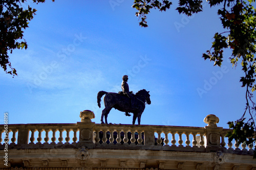 Statue of Alfonso XII with perspective simulating walking on a balustrade photo