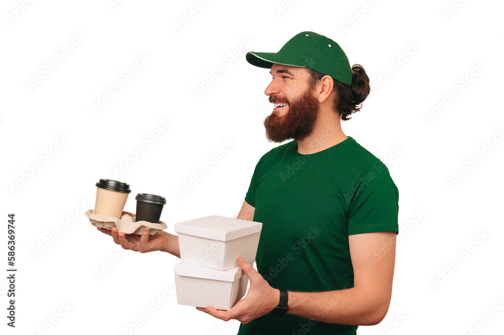 Delivery man wearing green holds two lunch carton boxes and to go cups of coffee. Delivery man wearing green holds two lunch carton boxes and to go cups of coffee.