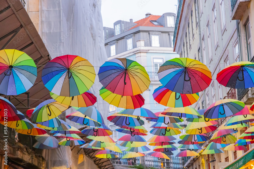Colorful umbrellas above a walking street in Lisbon.