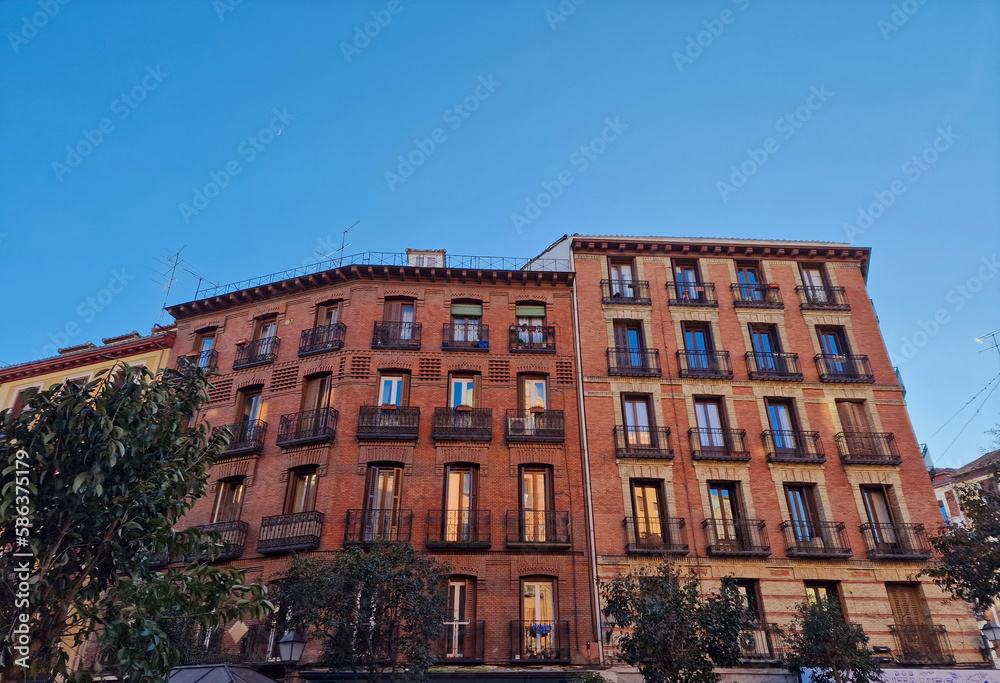 A fragment of an interesting tenement house in the center of Madrid on a sunny winter day in Madrid, Madrid, Spain.