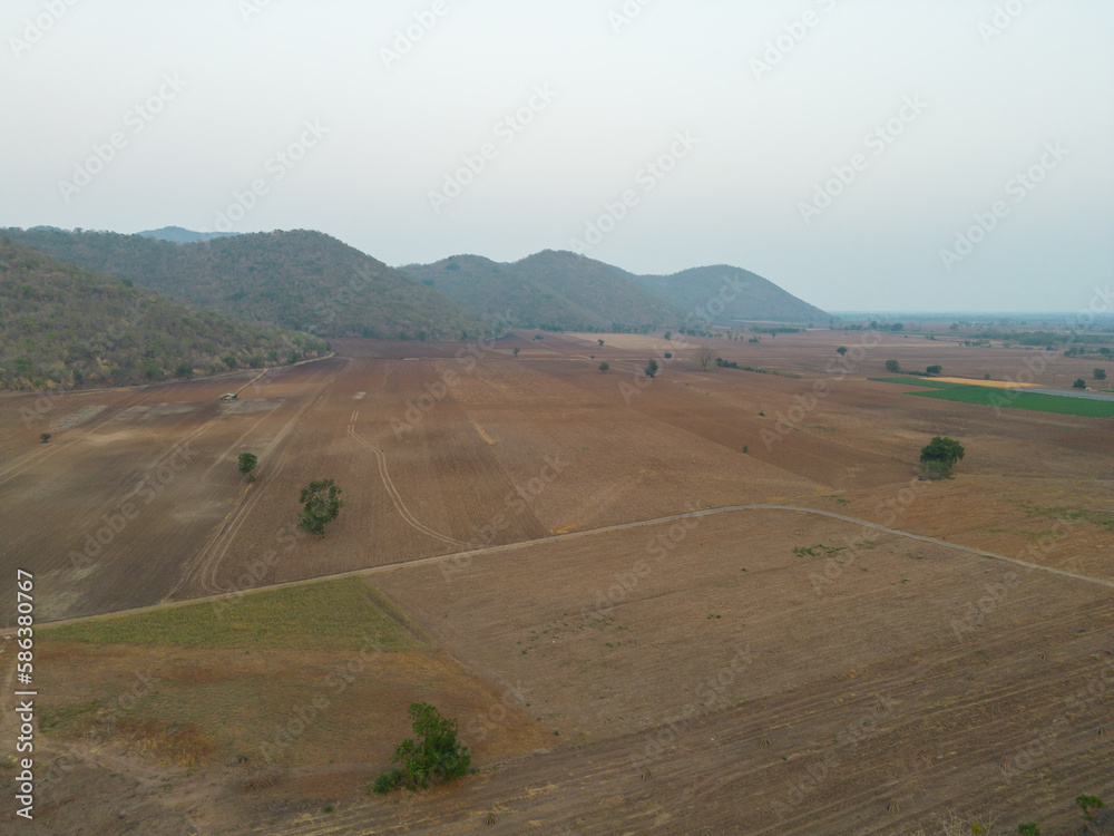 Obraz premium Aerial top view of paddy rice terraces, green agriculture fields in countryside, mountain hills valley, Thailand. Nature landscape. Crops harvest.