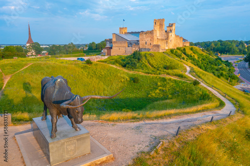 Aurochs Statue with Rakvere castle in background, Estonia photo