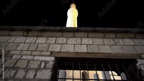 Minaret of the Ottoman-style Emperor's Mosque in Sarajevo at night, it's the first mosque built after the Ottoman conquest of Bosnia in 1457 photo