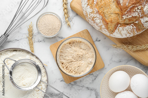 Flat lay composition with sourdough on white marble table