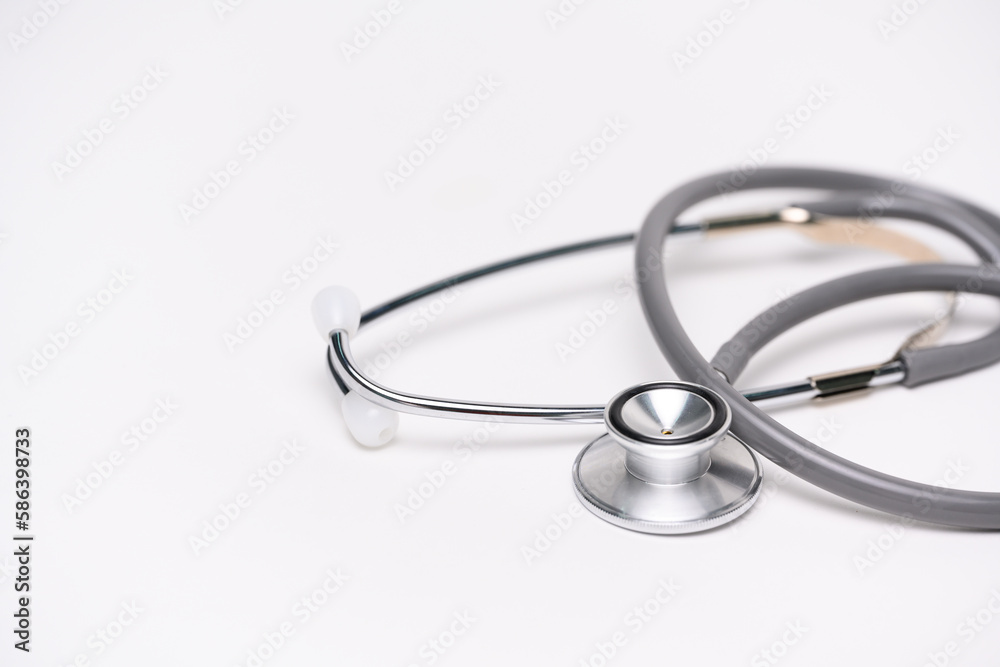 Medical gray stethoscope on white background and copy space for text.Medical or science with soft light background.Health care concept. Medical gray stethoscope on white background and copy space for text.Medical or science with soft light background.Health care concept.