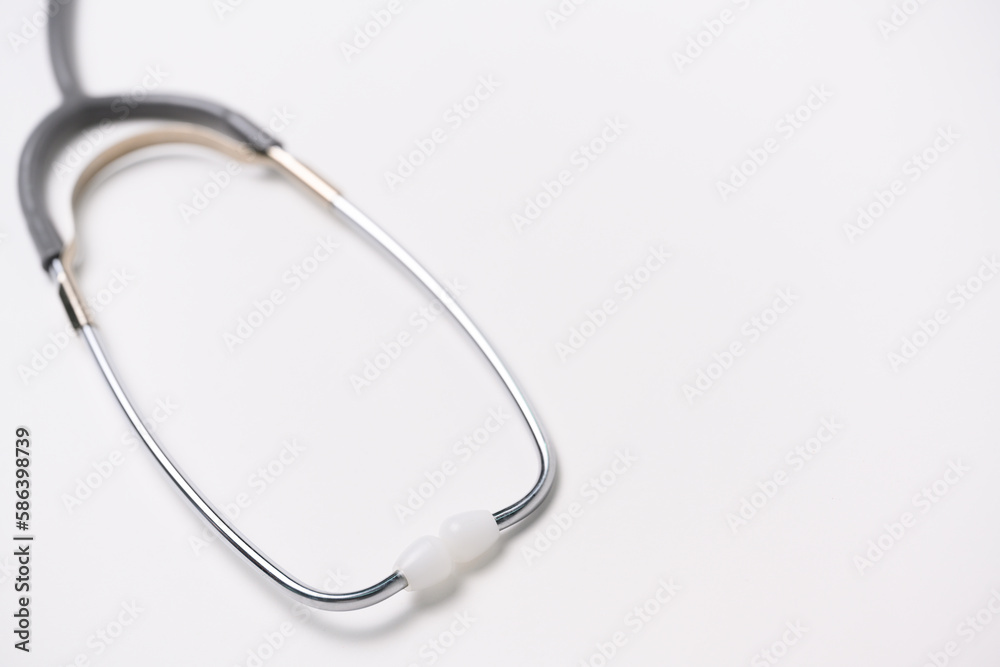 Medical gray stethoscope on white background and copy space for text.Medical or science with soft light background.Health care concept. Medical gray stethoscope on white background and copy space for text.Medical or science with soft light background.Health care concept.