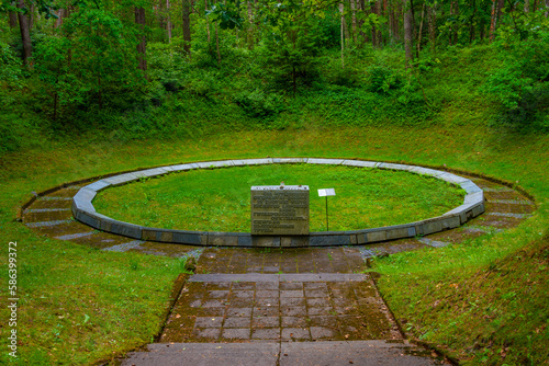 An excavated pit used to cremate corpses during Ponary massacre at Paneriai in Lithuania photo