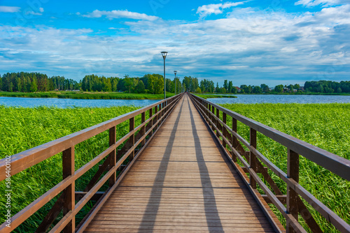 Wooden bridge over Sirvenos lake in Birzai, Lithuania photo