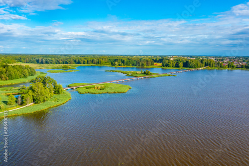Wooden bridge over Sirvenos lake in Birzai, Lithuania photo
