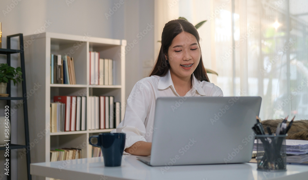 Young businesswoman manager watching online webinar training or having virtual meeting video conference on laptop computer. Young businesswoman manager watching online webinar training or having virtual meeting video conference on laptop computer.