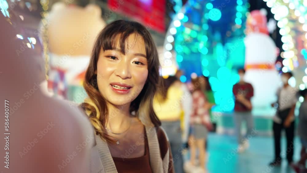 Point of view young Asian woman holding hands with boyfriends walking down city street at night. Happy couple enjoy and fun outdoor lifestyle shopping and travel in the city on summer holiday vacation Point of view young Asian woman holding hands with boyfriends walking down city street at night. Happy couple enjoy and fun outdoor lifestyle shopping and travel in the city on summer holiday vacation