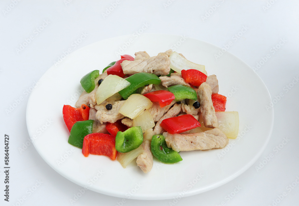 Top view. Delicious homemade Stir fried pork with sweet peppers, onion and black pepper on white plate. Top view. Delicious homemade Stir fried pork with sweet peppers, onion and black pepper on white plate.