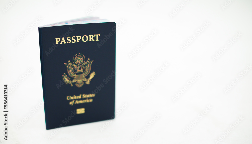 Close-up of a US passport with immigration, visa, citizenship, and travel paperwork on a wooden table