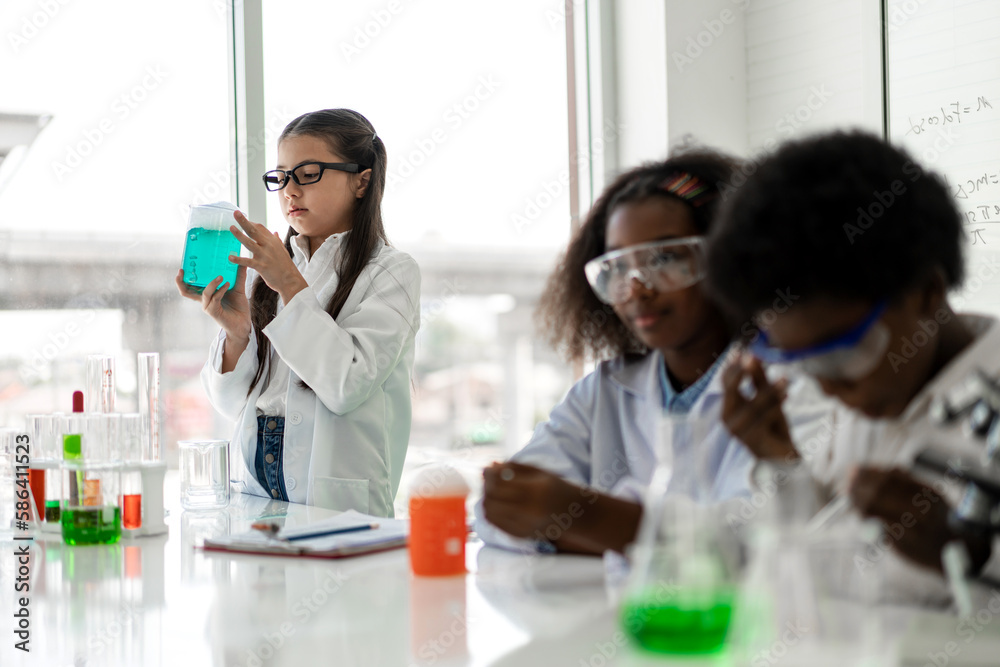 Group of teenage student learn science and study doing a chemical science experiment, biology class, classroom, children holding test tube on hand in experiment laboratory class at school.Education Group of teenage student learn science and study doing a chemical science experiment, biology class, classroom, children holding test tube on hand in experiment laboratory class at school.Education
