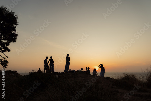 group of children playing in the sunset