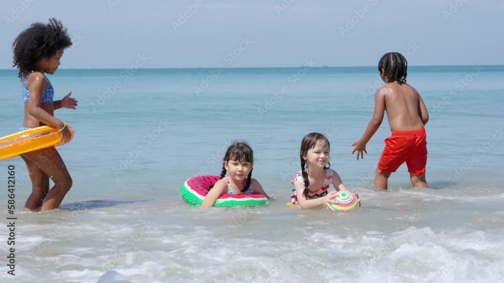 Group of Diversity little child boy and girl friends running and playing sea water at tropical beach together on summer vacation. Happy children kids enjoy and fun outdoor lifestyle on beach holiday.