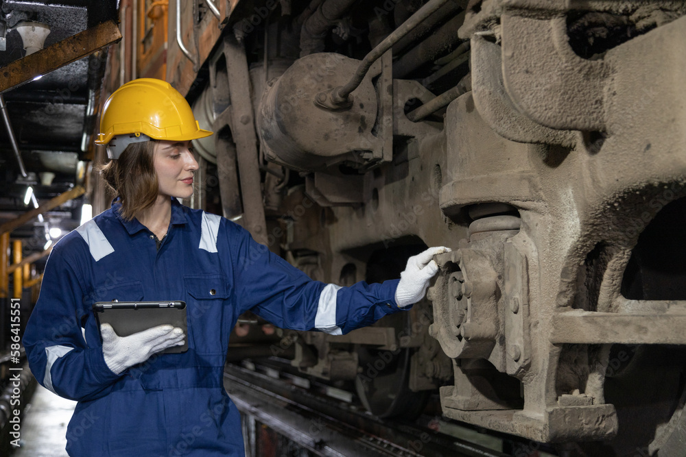 Portrait of Engineer train Inspect the train's diesel engine, railway track in depot of train Portrait of Engineer train Inspect the train's diesel engine, railway track in depot of train