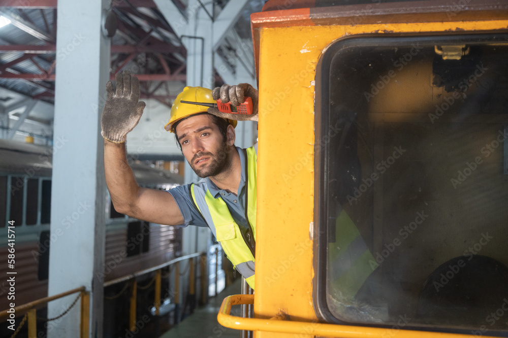 Portrait of Engineer train Inspect the train's diesel engine, railway track in depot of train Portrait of Engineer train Inspect the train's diesel engine, railway track in depot of train