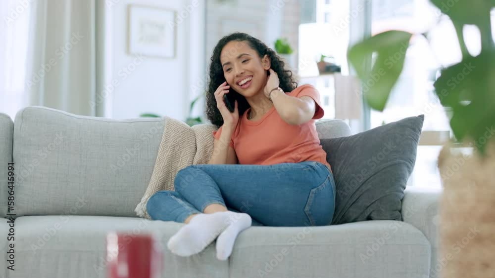 Phone call, gossip and a black woman on a sofa, sitting in the living room alone in her home to relax. Mobile, contact and conversation with an attractive young female chatting while in the house Phone call, gossip and a black woman on a sofa, sitting in the living room alone in her home to relax. Mobile, contact and conversation with an attractive young female chatting while in the house