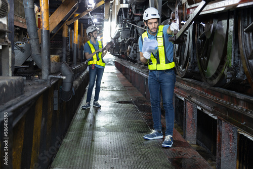 Engineer train Inspect the train's diesel engine, railway track in depot of train 