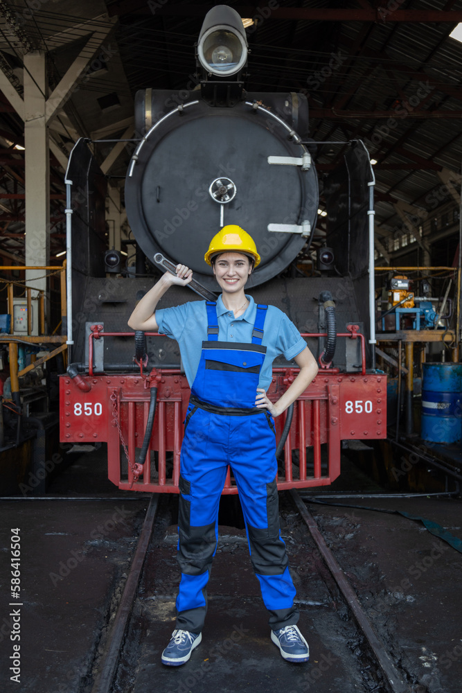 Portrait of Engineer train Inspect the train's diesel engine, railway track in depot of train
