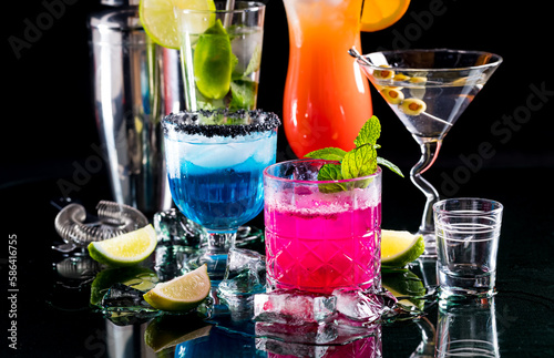 Bright colourful refreshing cocktails against a black background.