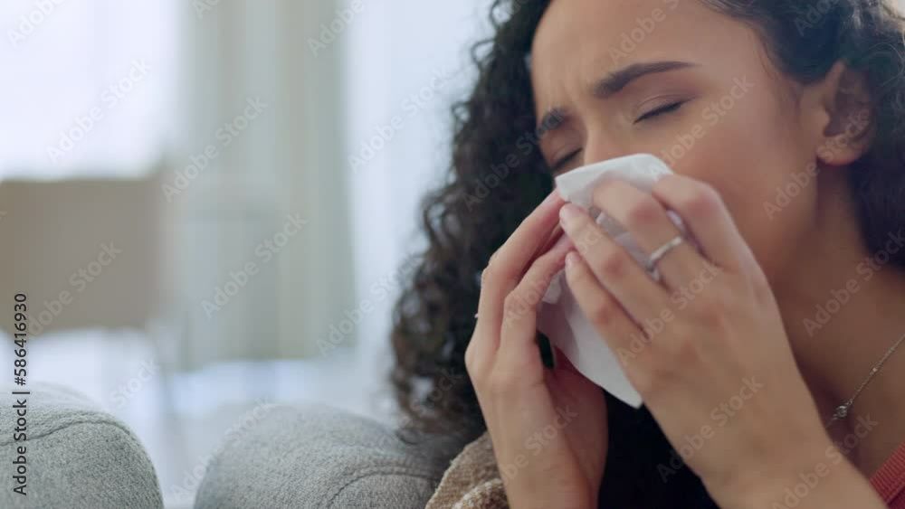Crying face, depressed and sad woman on a living room sofa with a tissue and mental health problem. House, anxiety and suffering of a mixed race female on a home lounge couch with tissues in distress