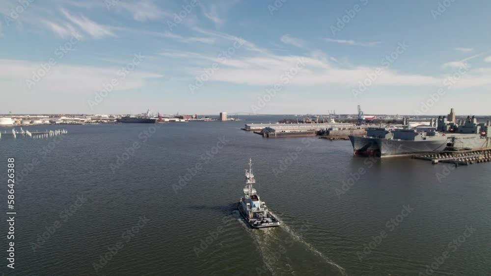 Drone panorama of tugboat in Baltimore harbor with US Navy ships Drone panorama of tugboat in Baltimore harbor with US Navy ships